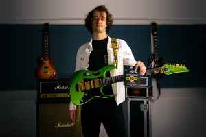 James Ford guitarist with Ibanez Pia guitar in green for Rotosound music strings. Ultramag UM10 guitar player