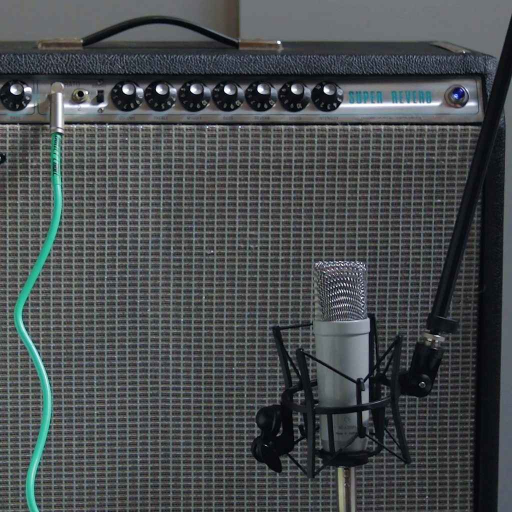 Rode condenser microphone on a Fender Super Reverb guitar amplifier