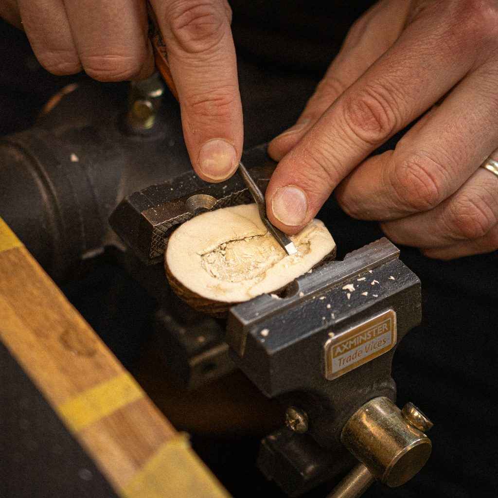 Tagua nut carving into a guitar nut